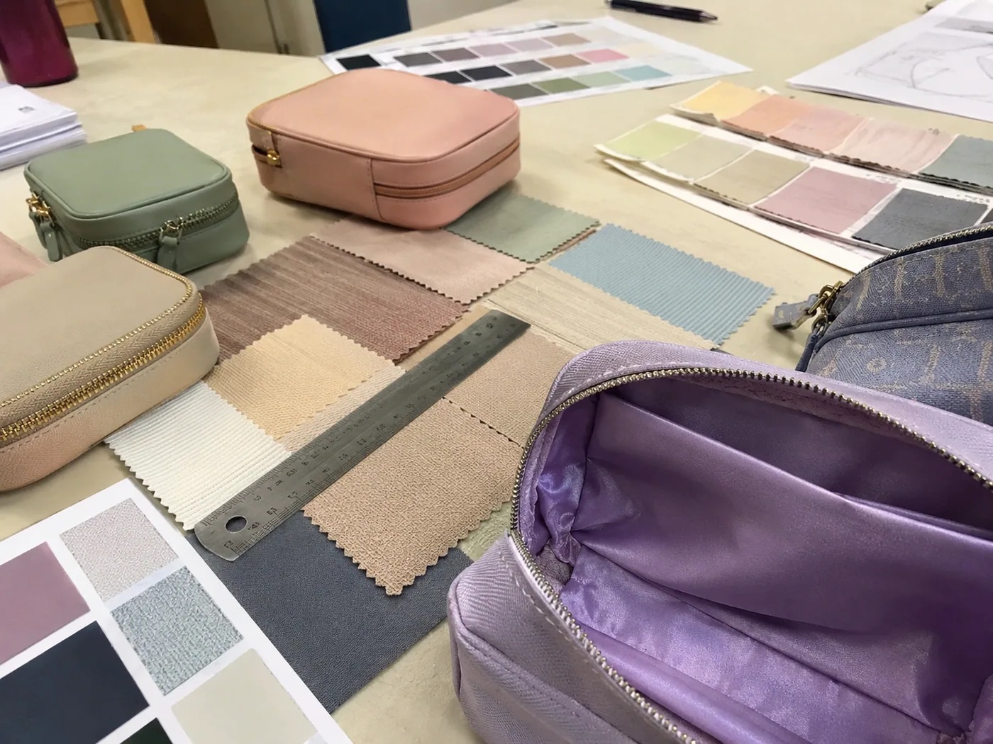 Smartphone-style cosmetic makeup bag prototype opened for lining seam and zipper-track inspection