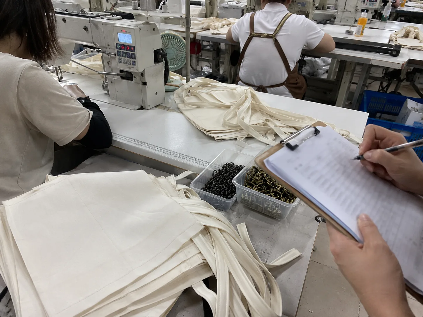 Bag sewing line production control with clipboard review